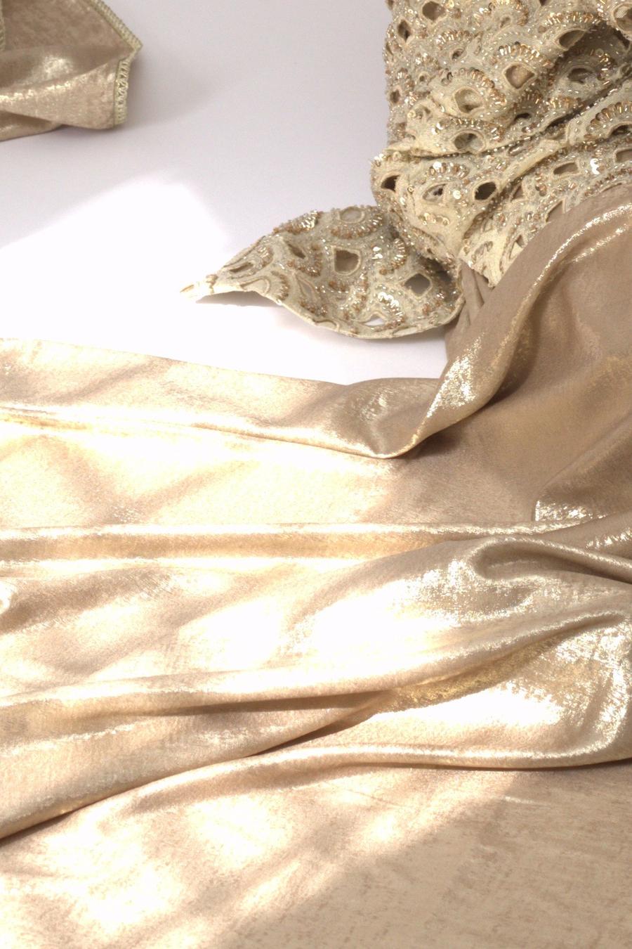 Antique gold draped balloon pants, close up of the soft metallic gold drape