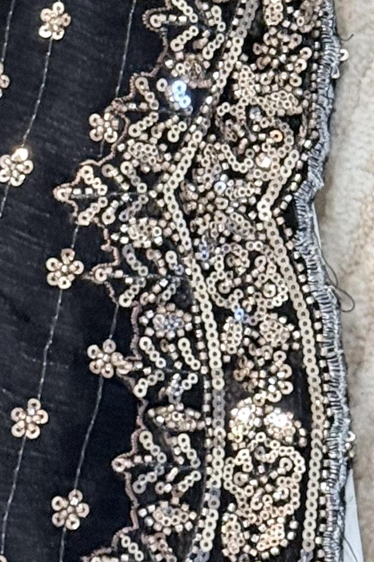 Black embroidered kurta, close up of the scalloped silver sequin and bead border
