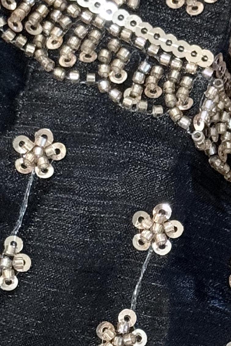 Black embroidered kurta, close up of the silver sequin flower motifs and bead trim
