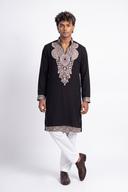 Black embroidered open neck kurta with white shalwar, full length front view on a model