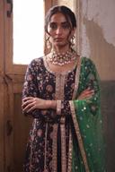 Black frock with multicolor thread flowers and silver borders, waist up view with the green net dupatta over one shoulder
