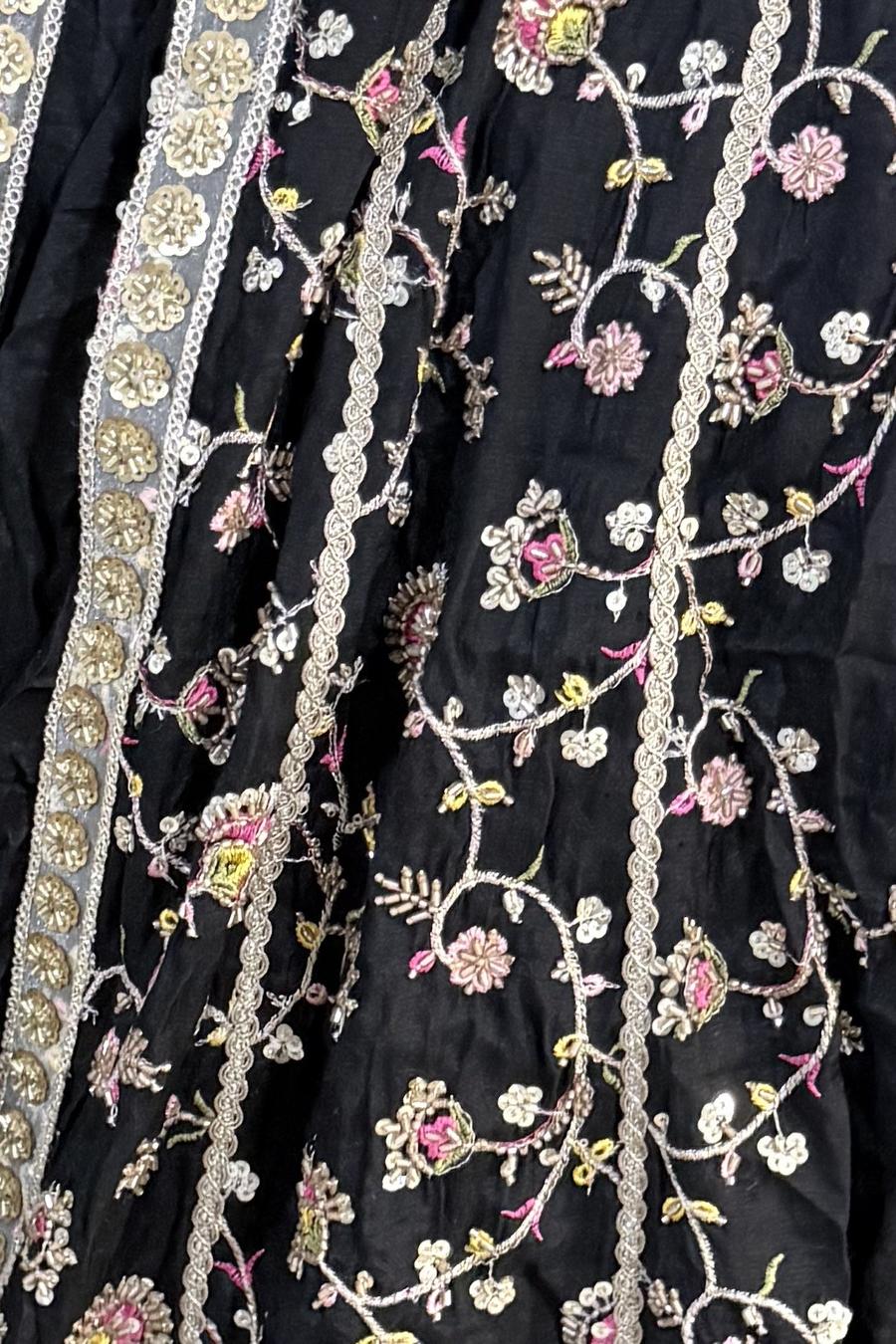 Black long frock, close up of the multicolor thread flower vines and silver borders