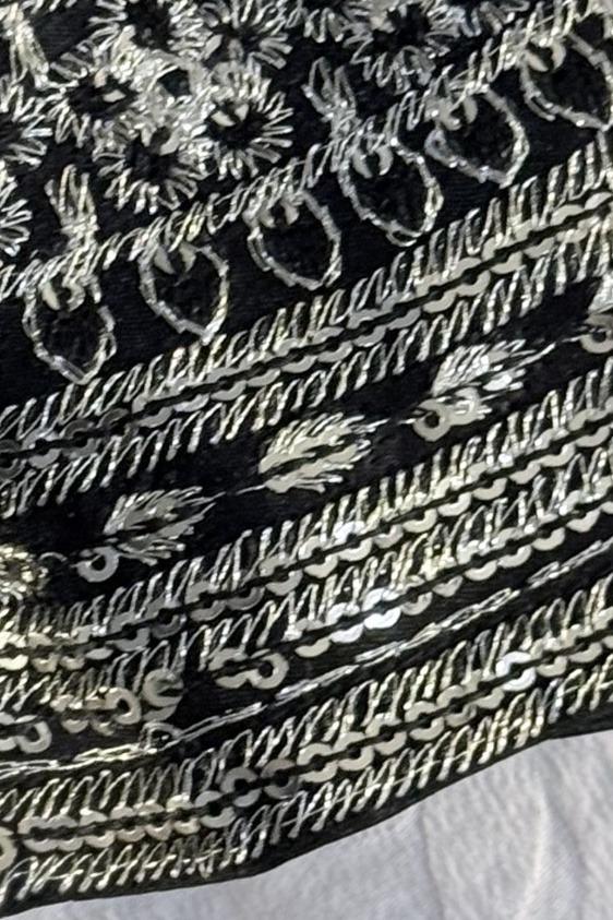 Black long shirt, close up of diagonal silver thread bands and sequin flowers