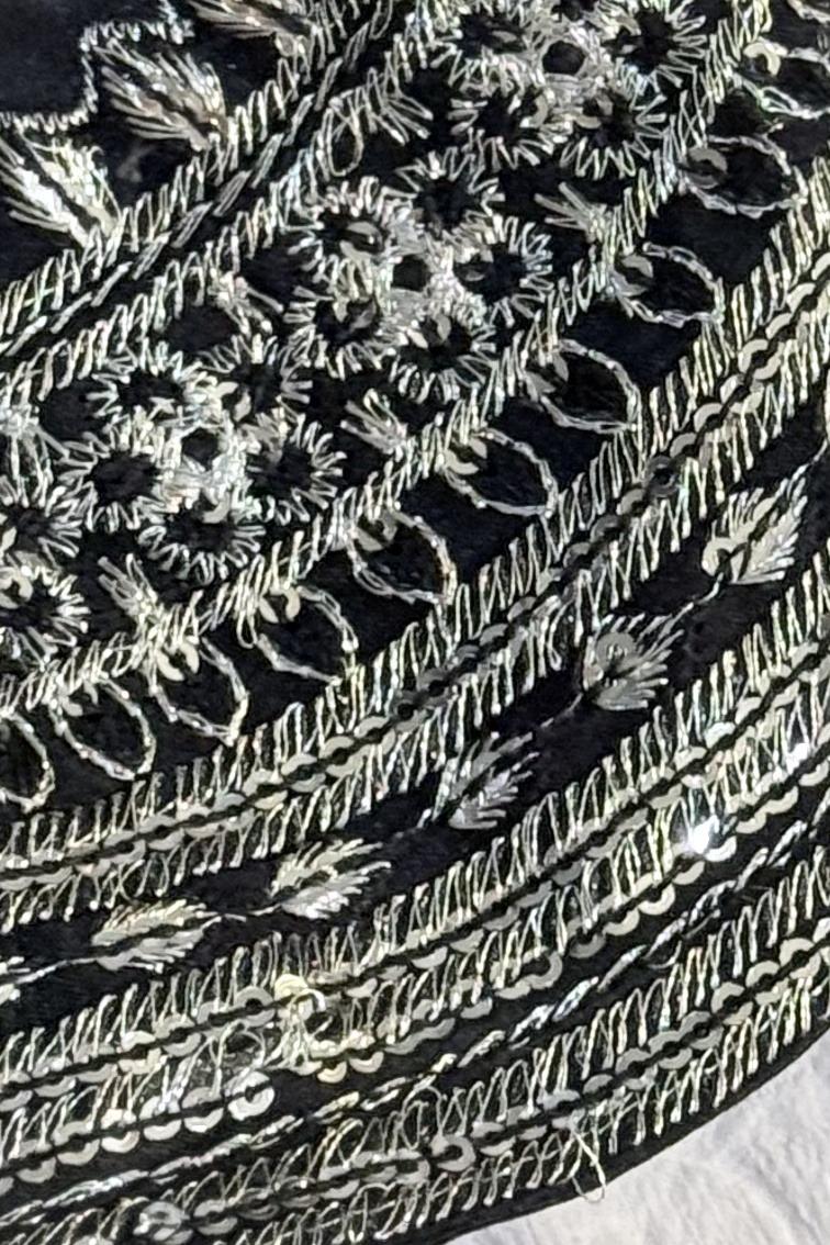 Black long shirt, close up of silver thread stripes and floral medallions