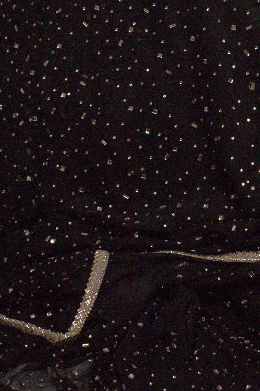 Black shimmer shirt, close up of the scattered sequin fabric and silver trim