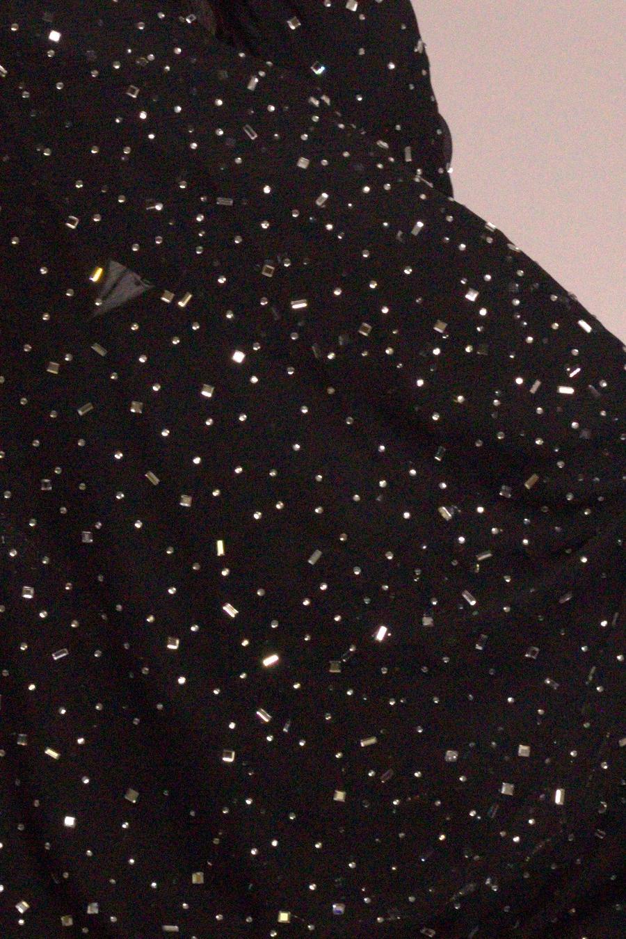 Black shimmer shirt, close up of the scattered sequins on the sleeve