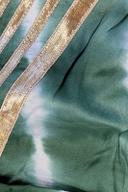 Green tie dye izzar, close up of the white tie dye pattern and gold stripe trim