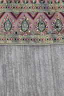 Blush mirror work shirt, close up of the embroidered hem band above the crinkled fabric