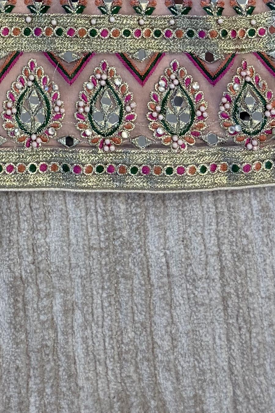Blush mirror work shirt, close up of the embroidered hem band above the crinkled fabric