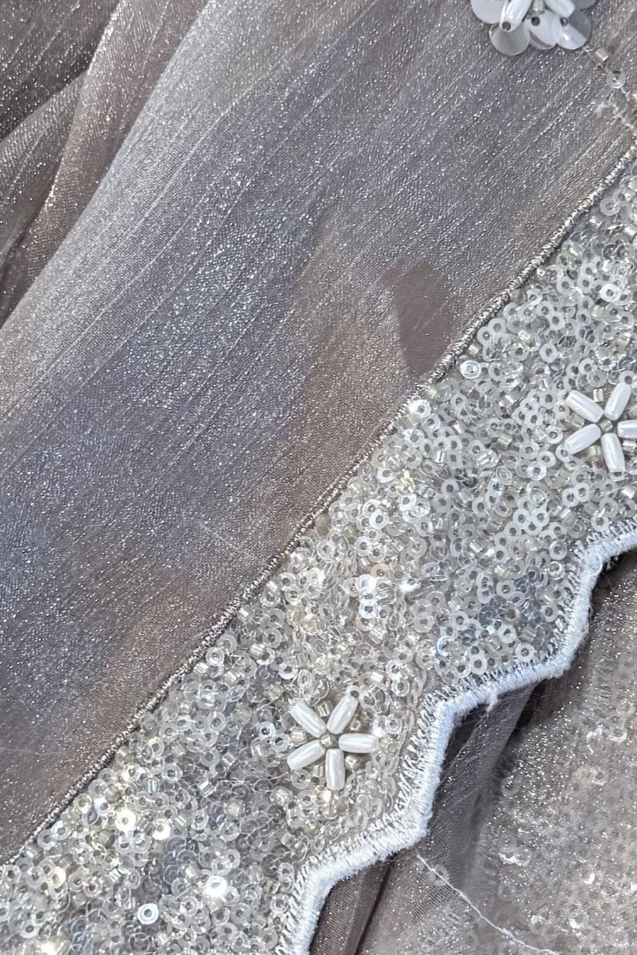Champagne sequin flared lehenga, close up of the scalloped sequin border with bead flowers