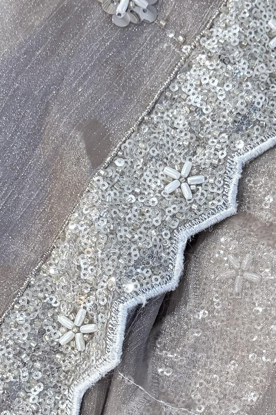 Champagne peplum, close up of the scalloped silver sequin hem with bead flowers