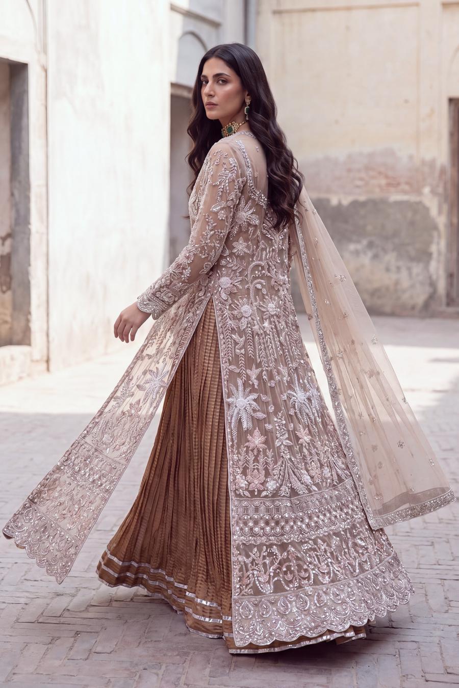 Champagne embroidered peshwas from behind, sheer net train and dupatta in motion