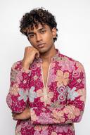 Fuchsia silk kurta, waist up, open collar with cream and gold cord and gold outlined florals