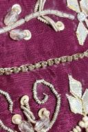 Red hand embroidered trousers, close up of pearl beads, silver bugle leaves and sequin scrolls