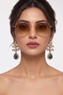 Model wearing Wear Wali emerald and onyx Victorian leaf earrings in antique gold, with pierced gold leaves