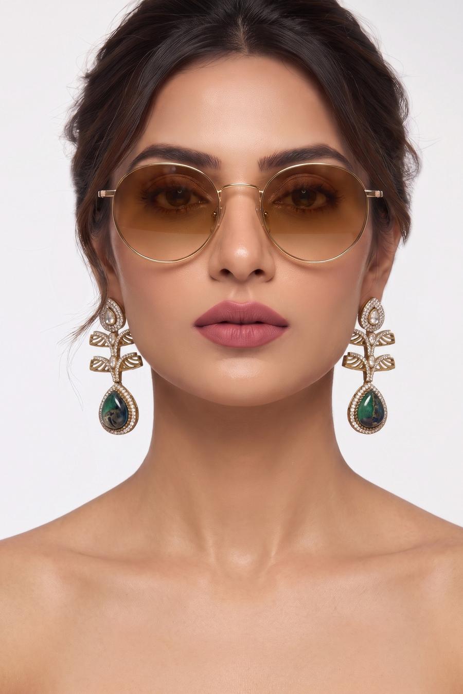 Model wearing Wear Wali emerald and onyx Victorian leaf earrings in antique gold, with pierced gold leaves