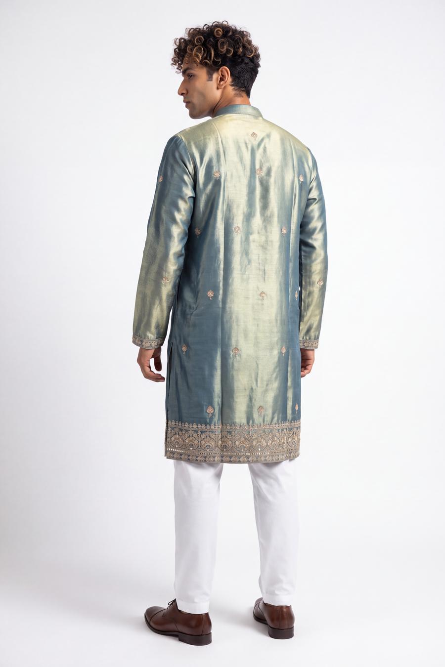 Back view of the green tissue silk kurta with gold buti motifs and deep embroidered hem border