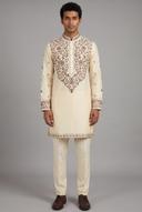 Ivory men's kurta with chocolate brown embroidery at the collar, placket and cuffs, worn with plain ivory trousers, full length
