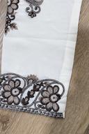 Macro close up of the chocolate brown embroidered cuff on the ivory men's kurta