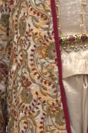 Ivory embroidered jacket, close up of the red and olive floral embroidery and wine edging