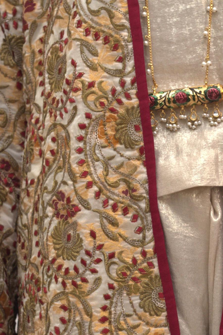 Ivory embroidered jacket, close up of the red and olive floral embroidery and wine edging