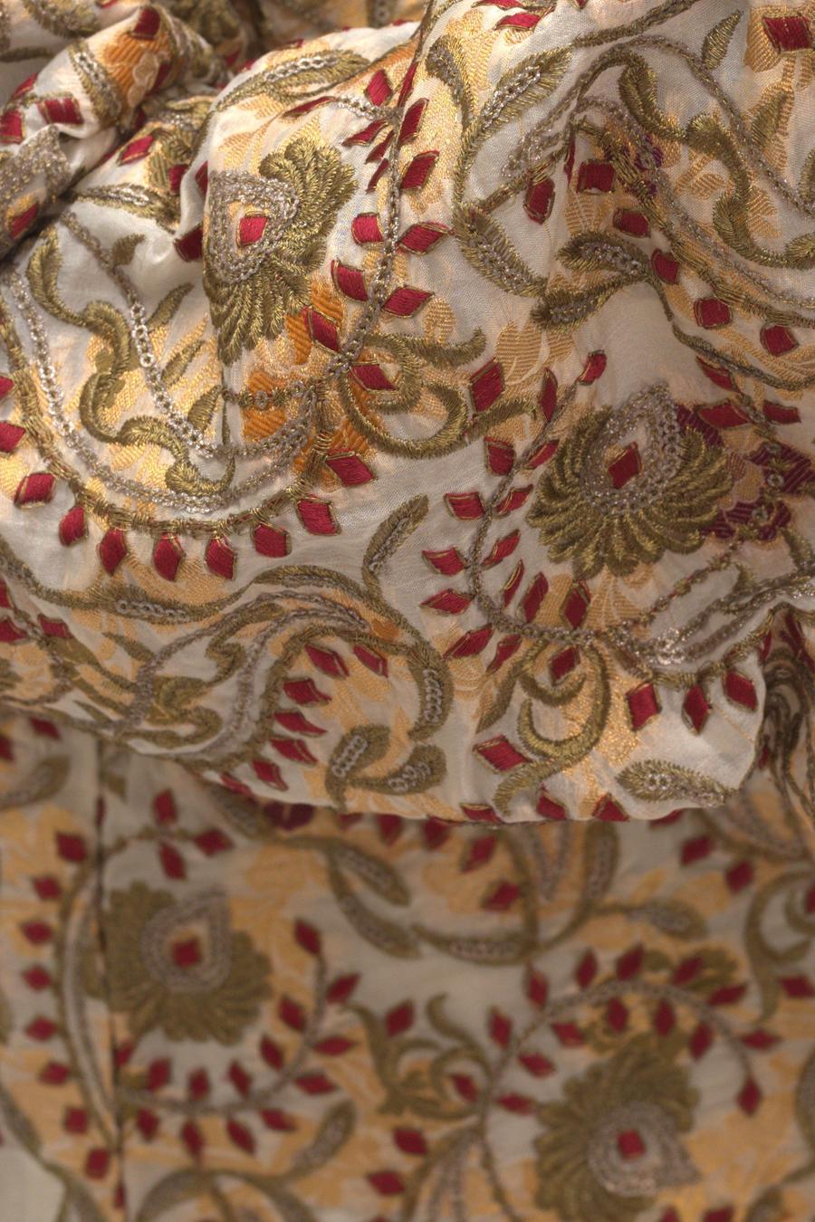 Ivory embroidered jacket, close up of the red, gold and olive floral pattern