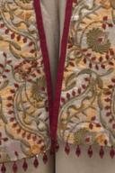 Ivory embroidered jacket, close up of the floral embroidery and bead fringe hem