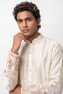 Ivory kurta, waist up, closed rounded collar and buttoned placket with white bead motifs