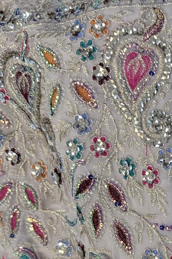 Ivory sequin lehenga, close up of multicolor paisleys and sequin flowers on the hem border