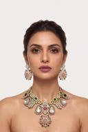 Model wearing the Wear Wali jewel tone medallion bib necklace in gold, set with clear polki and pastel cabochons