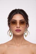 Model wearing Wear Wali floral hoop earrings in gold, alternating baroque pearls with mint pave teardrops