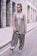 Silver jaali net jacket over metallic draped balloon pants, full length three quarter view