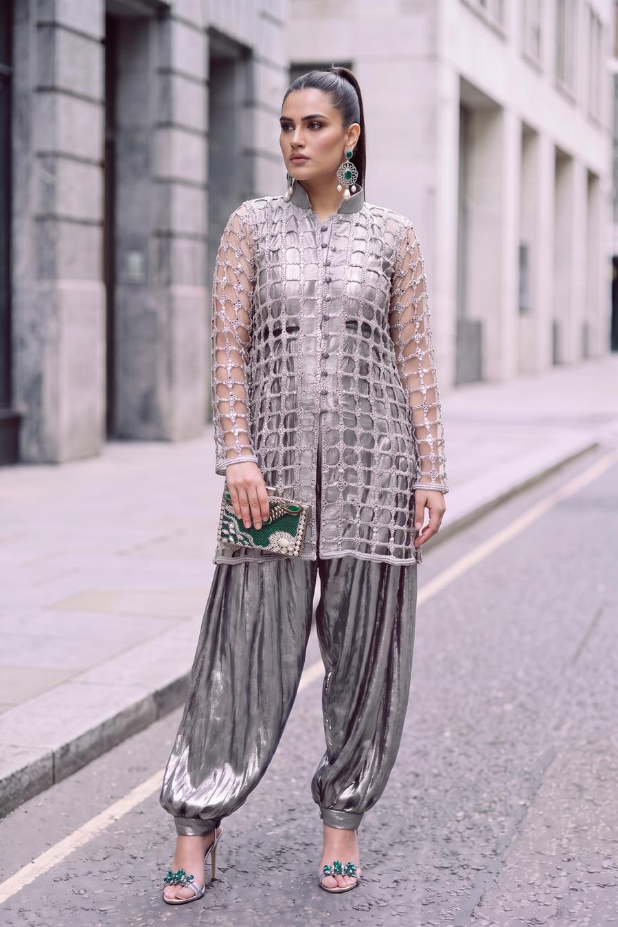 Silver jaali net jacket over metallic draped balloon pants, full length three quarter view