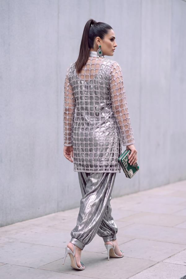 Back view of silver jaali net jacket and gathered metallic balloon pants with cuffed ankles