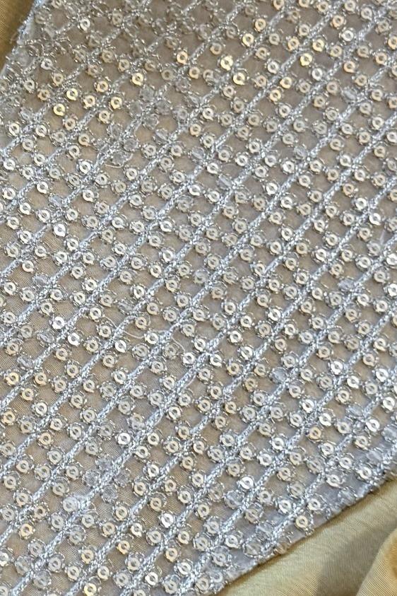 Mustard long shirt, close up of the silver sequin and thread grid work on sheer fabric