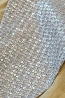 Mustard long shirt, close up of the silver sequin lattice over a gold lining