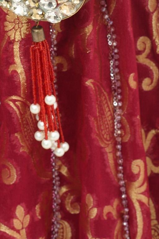 Red banarasi long shirt, close up of the gold weave, bead lines and pearl tassel