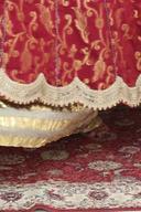 Beige sharara under the red banarasi long shirt, close up of the scalloped pearl hem