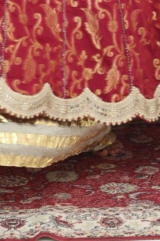 Beige sharara under the red banarasi long shirt, close up of the scalloped pearl hem