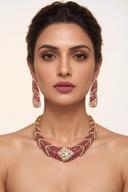 Model wearing the Wear Wali ruby kundan hasli collar necklace in antique gold, with matching drop earrings