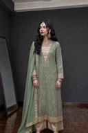 Sage green embroidered shirt with gold trousers and sage dupatta, full-length standing view indoors