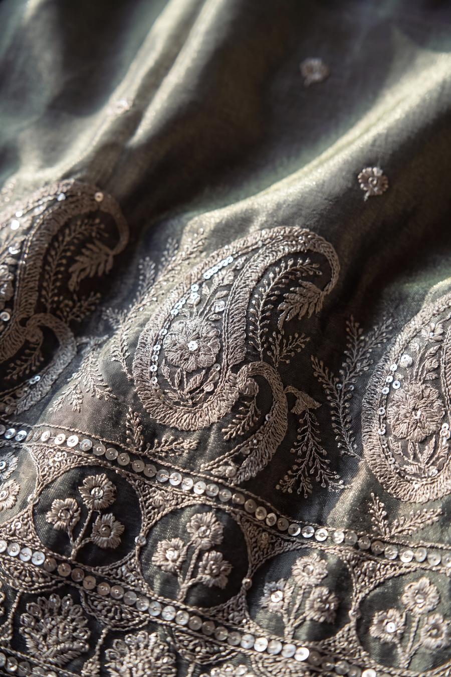 Close up of the sage kurta hem: pewter silver paisley and rosettes with a sequin packed edge
