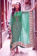 Teal sequin kaftan-style long shirt with sheer embroidered sleeves, full length with one arm raised