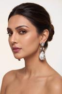 Model wearing Wear Wali white howlite Victorian drop earrings in antique gold, each with a clear polki top